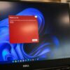 a dell laptop computer with a red screen