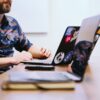 man sitting in front of laptop